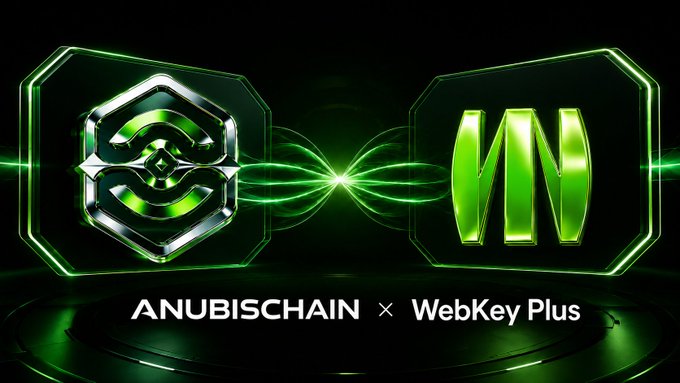 A sleek promotional graphic features two glowing green and silver logos—an AnubisChain emblem on the left and a stylized "M" on the right—connected by an electric green energy beam, with the text "ANUBISCHAIN × WebKey Plus" displayed below on a dark reflective background, symbolizing the reunion and new dual-chain partnership between the two platforms.