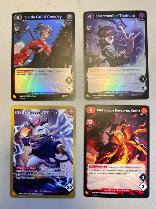 Four collectible trading cards displayed together, featuring 'Trade Guild Cavalry', 'Stormcaller Tenkichi', 'Piko of Thousand Blades', and 'Gluttonous Devourer, Kasho', each with detailed anime-style artwork.