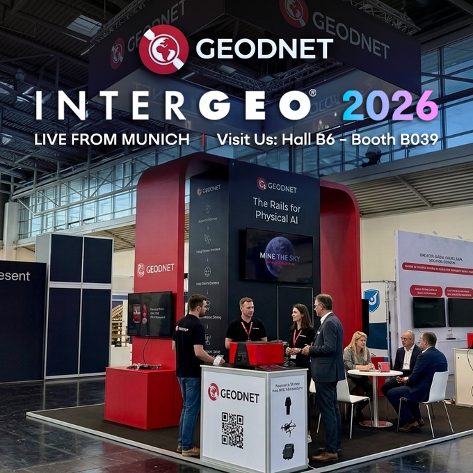 The image shows the GEODNET booth at INTERGEO 2026 in Munich, with staff engaging visitors and promoting their "Rails for Physical AI" theme and "Mine the Sky" campaign at Hall B6, Booth B039. The scene captures the wrap of Day 1, featuring attendees discussing decentralized RTK and survey-grade precision solutions.