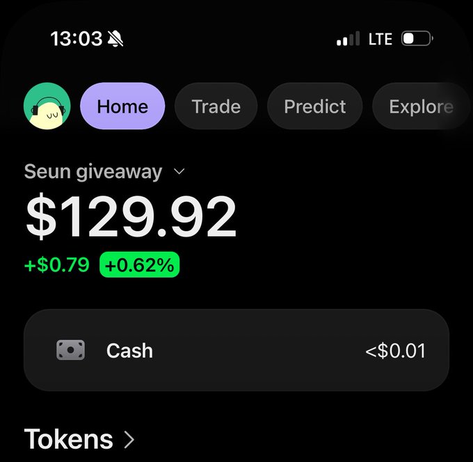 A smartphone screenshot shows a crypto trading app displaying a portfolio under the title "Seun giveaway" with a balance of $129.92, reflecting a gain of +$0.79 (+0.62%), and an almost empty cash balance of <$0.01, supporting the post's promise of an airdrop giveaway.