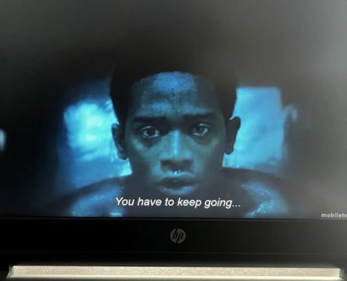 A photograph of an HP monitor displaying a scene from a movie showing a young man's face with the subtitle 'You have to keep going...' and a 'mobiletv' watermark.