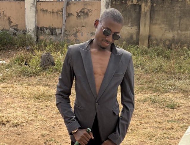 A young man wearing dark sunglasses and an open grey blazer (with no shirt underneath) poses confidently in an outdoor setting, suggesting his newfound financial success. The image directly supports the post's narrative about Web3 transforming his lifestyle and appearance.