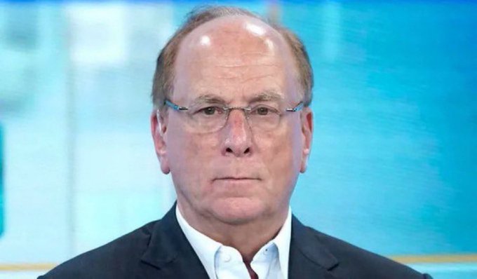 Larry Fink, head of BlackRock, the asset management giant whose Bitcoin ETF (IBIT) made a major $115.4 million BTC purchase as noted in the post, is shown in what appears to be a news broadcast interview setting.