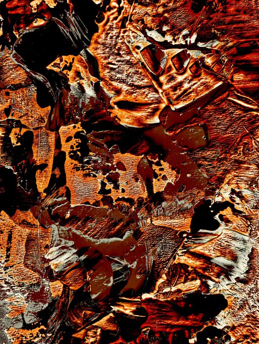 An abstract, heavily textured image featuring metallic and reddish-orange tones with glossy, fragmented surfaces.