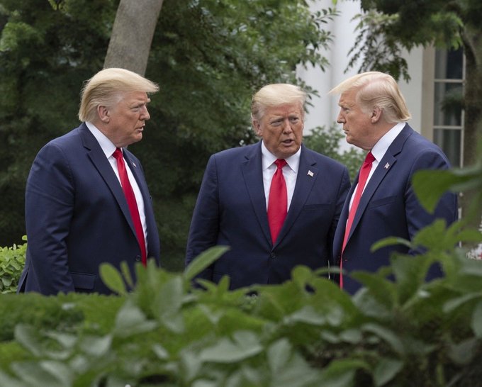 Three men in dark suits and red ties, resembling Donald Trump, stand conversing outdoors in front of greenery.