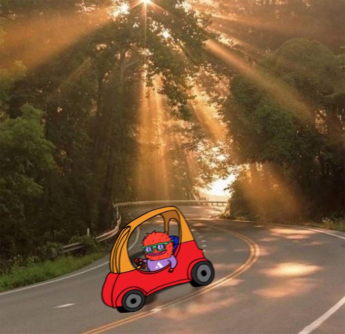 A cartoon character with orange hair and green sunglasses drives a small red and yellow car down a sunlit, tree-lined road, perfectly illustrating the "motion this summer" vibe of the GM $AVAX community post.
