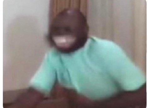 A blurry meme image of a person wearing a brown animal/bear hood mask and a mint green shirt.