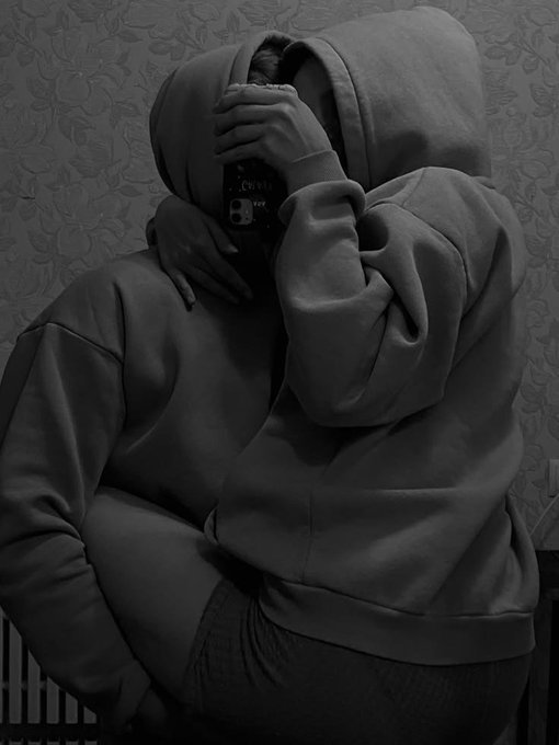 A person in a hoodie sits hunched over, face hidden in their hand while holding a phone, rendered in a dark, grainy aesthetic that conveys exhaustion or contemplation, pairing with the post's weary "gn" (good night) sign-off as they reflect on the day before logging off.