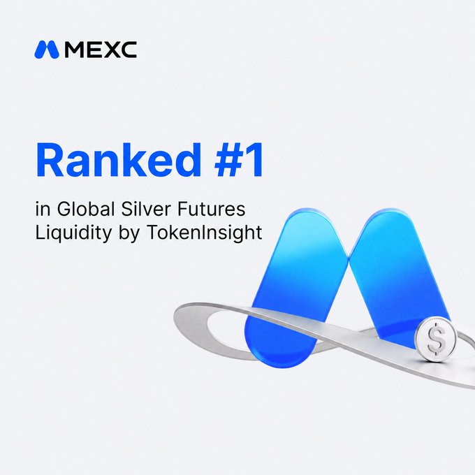 The image features a silver coin with the word "MEXC" written above it, along with the text "Ranked #1 in Global Silver Futures Liquidity by tokens Insight". The coin has a blue background and is placed on top of a white surface. The text "MEXC ranked #1 in Global Silver Futures Liquidity by tokens Insight" indicates that the coin was awarded first place for its position among all coins in terms of liquidating value, with the lowest slippage and tightest spread.