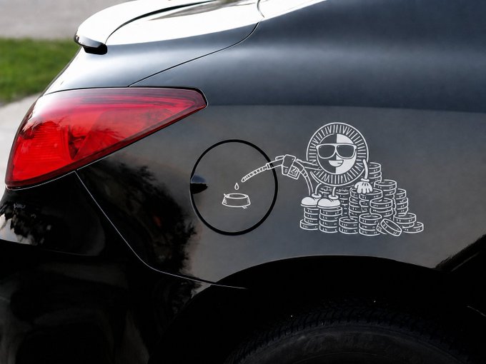 A white cartoon decal on the rear of a black car depicts a smiling coin with sunglasses, fueling a sports car while standing next to a pile of money, playfully illustrating the post's message of "Keep the Gas savings" by showing coins being saved instead of spent on fuel.