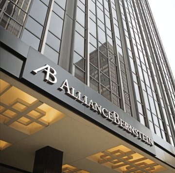 The exterior of a tall office building displays a sign reading 'AB ALLIANCEBERNSTEIN' above its entrance.