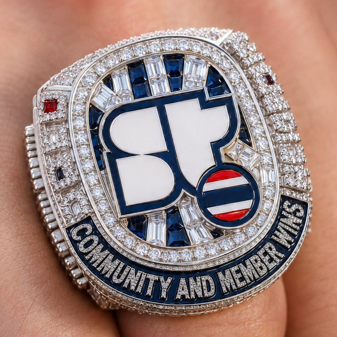 A close-up shows an ornate championship ring featuring a large 'B' logo, encrusted with diamonds and blue stones, with the inscription 'COMMUNITY AND MEMBER WINS' along the bottom.