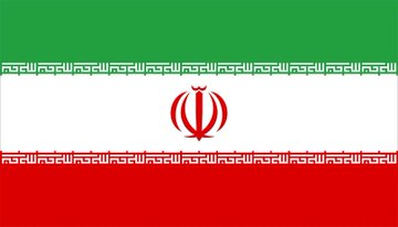 The image shows the flag of Iran, featuring its characteristic green, white, and red horizontal stripes with the red national emblem in the center. It relates to the post about Iran's "Persian Gulf Strait Authority" imposing new transit fees on ships, as the flag visually represents Iran as the entity implementing these cryptocurrency-accepting payment policies.