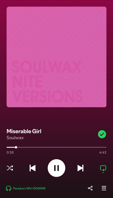 A Spotify music player screen displaying the song "Miserable Girl" by Soulwax, with the album art shown as a pink diagonal-striped placeholder image.