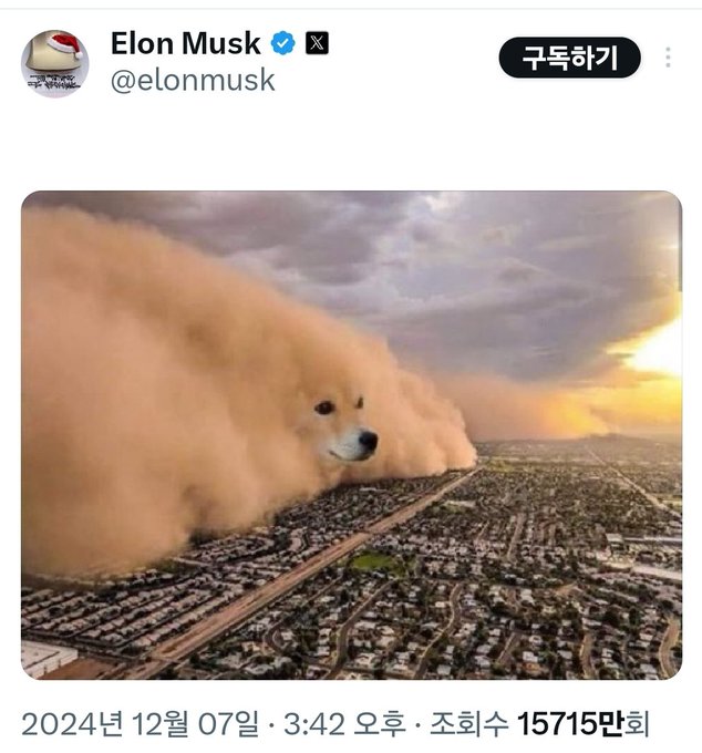 The image features an aerial view of a city with a large sandstorm blowing over it. A dog's head can be seen in the center of the image, surrounded by the dust cloud from the sandstorm. The caption below the photo reads "X Money, a sandstorm devouring the existing financial system". This post is about a sandstorm that has blown over a city and is related to the concept of money being blown away or destroyed by the storm.