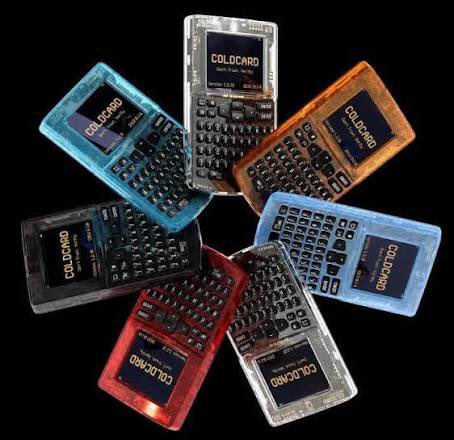 Coldcard Mk4 hardware wallets in various colors (blue, black, red, orange, and clear) arranged in a circular pattern, each displaying the "COLDCARD" boot screen, with the accompanying post indicating that Coldcard has issued an urgent security warning urging Mk3 and Mk4 users to transfer their Bitcoin to new wallet addresses due to an exploited vulnerability.