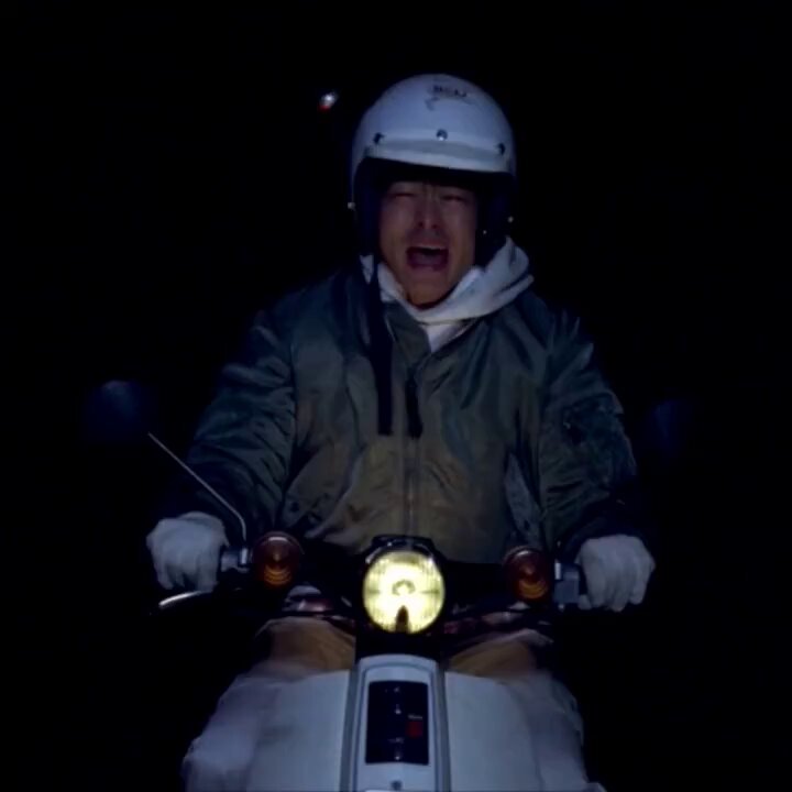 The image shows a person wearing a white helmet riding a motorcycle or scooter at night with their head down. The rider appears to be alone, not sharing the ride with any companions. The surrounding area seems dark, which adds a sense of mystery to the scene. The photo has been shared on social media where the image caption includes an interesting story about Bitcoin in relation to the post: "in  2021, I bought Bitcoin at $26k and ignored everyone else just as Bitcoin rose sharply by 120k that year fomo bought back at $123k and now Bitcoin is worth $60k. Focus on what it says". The image seems to be promoting an event or story related to Bitcoins being used for purchases in the past, with a sense of adventure and excitement captured within this scene.