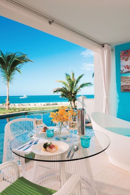 𝕏 Family Happy Taco Tuesday can be seen as a theme for this image, with a dining table set up outside near a pool area. The table has plates of food, glasses, and utensils such as forks and knives on it. A vase filled with yellow flowers is placed in the center of the table. In the background, there are palm trees swaying under the blue sky, adding to the tropical ambiance. The post also mentions a "Wallchain" and a "Pact Swap", which could be related to the dining experience or the overall theme of the image.