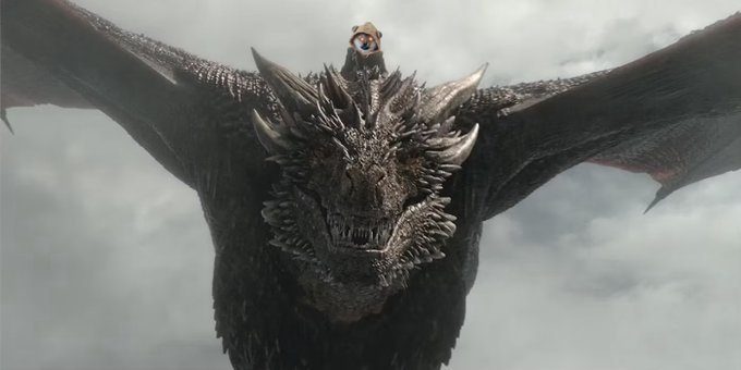 A rider sits atop a massive, fearsome dragon with outstretched wings against a dramatic cloudy sky, appearing to be from a fantasy film or TV series.