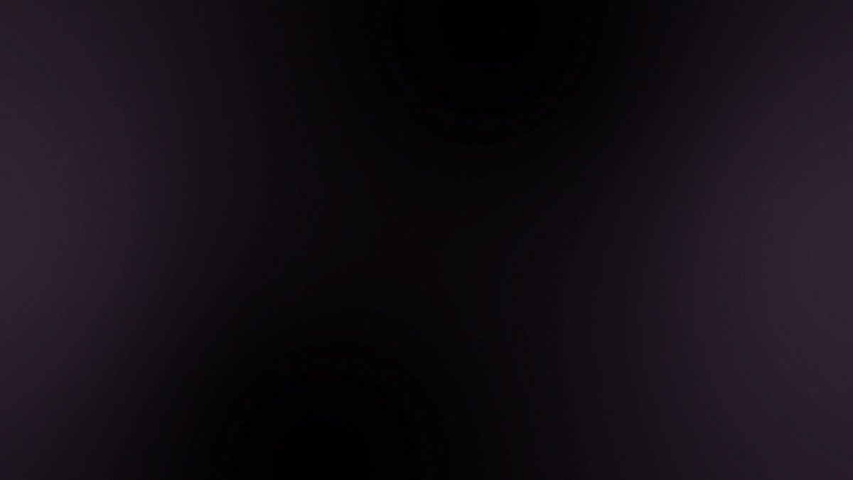 The image shows a close-up view of a gray square, which appears to be a computer screen or monitor displaying an image with black and purple colors. The background of the image is dark, creating a contrast between the light gray square and the darker background. There are no texts or other objects in the image, making it a simple and uncluttered composition focused on the displayed content.