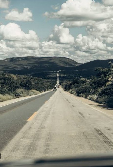 An open highway stretches toward distant mountains beneath a cloudy sky, with a few vehicles traveling ahead on the long, empty road. The image metaphorically reflects the post's message about Canopy ($CNPY) being a long road of infrastructure building toward a transformative destination, where the end goal is making Web3 creation nearly costless through AI and blockchain.