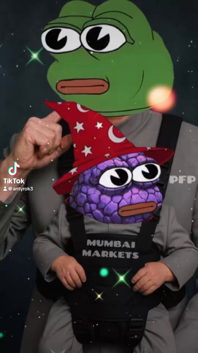 The image features a person wearing a green frog mask, which appears to be a cartoon character or a frog-like creature with a red hat. The person is holding a child who is dressed in a gray outfit. The background of the image has a dark blue color and includes stars scattered throughout it. The caption "MUMBAI MARKETS @pumpfun_pepe" suggests that this scene might be related to an event or gathering involving the character "Mumbai Markets".