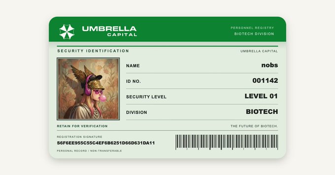 A fictional Umbrella Capital security ID card displaying the name "nobs," ID No. "001142," Security Level "LEVEL 01," and Division "BIOTECH," featuring artwork of a winged figure blowing a bubble gum bubble. The Resident Evil-themed post humorously presents this as an official "personnel registry" badge tied to the creator's wallet signature, riffing on Umbrella Corporation's biotech division aesthetic.