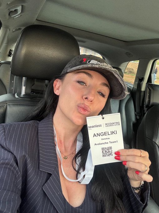 A woman in a blazer and cap holds up a name badge reading 'ANGELIKI', 'seamless ACCOUNTING', 'Dotikas', 'Avalanche Team1' with a QR code.
