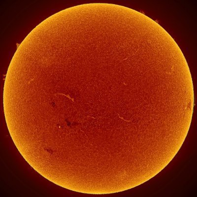 A close-up view of the Sun, rendered in vivid orange and red hues, reveals its textured, granular surface and faint solar filaments against a dark background—perfectly capturing the fiery essence of the "Sol rises again" caption.