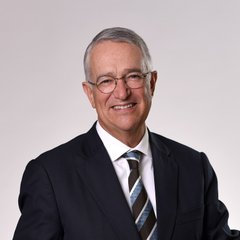 Ricardo Salinas Pliego, the billionaire Mexican businessman, pictured in a professional headshot wearing a dark suit, striped tie, and glasses.