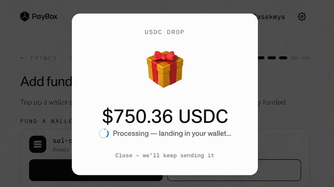 A screenshot of the PayBox app showing a "USDC DROP" notification for $750.36 USDC being processed to the user's wallet, accompanied by a gift box icon, illustrating the claim that funds are still being received.