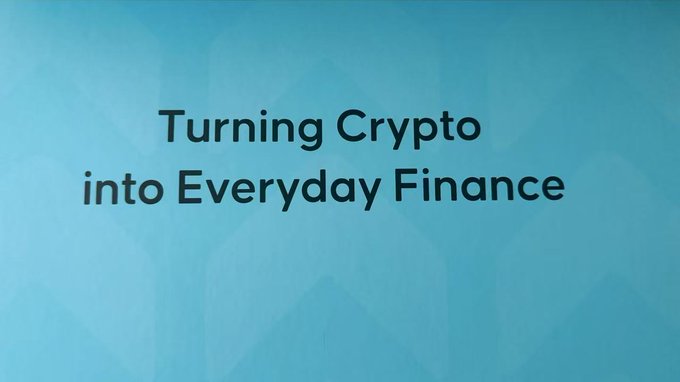 A blue gradient background with the text 'Turning Crypto into Everyday Finance'.