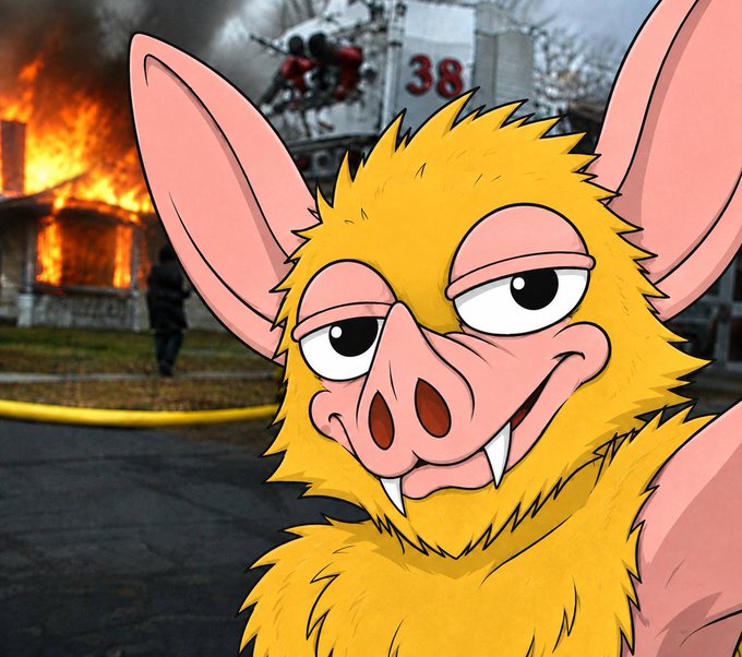 A cartoon bat creature with yellow fur, large pink ears, and prominent fangs stares smugly at the camera, photoshopped in front of a real photo of a house engulfed in flames with a fire truck marked "38" and firefighter battling the blaze in the background. The image humorously contrasts the chaotic disaster scene with the character's unbothered, scheming expression, fitting the "gm hoodrats…we go again" post that suggests a return to chaotic or mischievous energy.