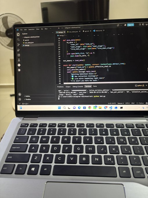 A laptop screen displays Python code for a Telegram bot (`bot.py`) using `python-telegram-bot`, with the terminal showing execution output. The code includes `save_data`, `load_data` functions and commands like `/start` that respond to user messages, aligning with the post about building and testing a new Telegram bot.