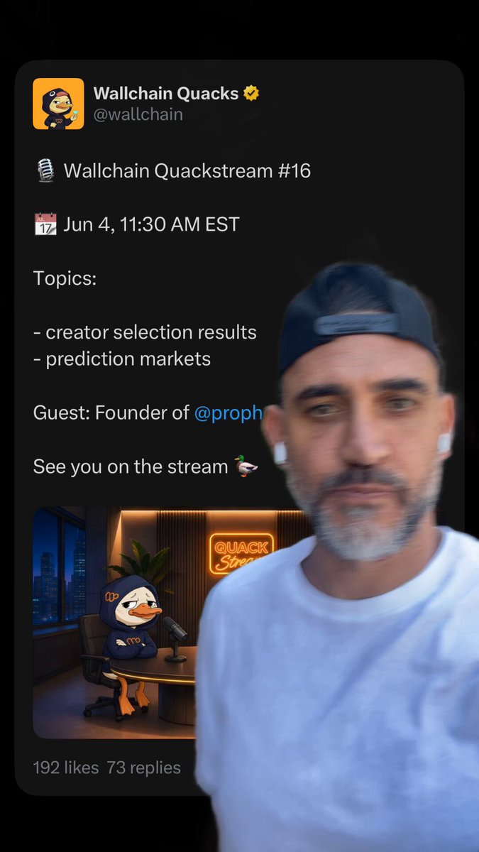 The image shows a man wearing a white t-shirt with a cartoon duck on it, standing next to his phone screen. On the screen of his phone, there's a Twitter post from Wallchain Quackstream, which reads "Wallchain Quackstream #quacks #wallchainquacks". The post also mentions that the creator of the stream is @prophetmarketai and that they are hosting a live stream on June 4th at 11:30 AM.