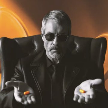 A black-and-white photo shows Michael Saylor, the Bitcoin advocate and executive chairman of Strategy, wearing dark sunglasses and a black jacket while seated and holding out his hands, with an orange-tinted, high-contrast background highlighting him. The image visually anchors the news that his company is committing $250 annually to Trump's investment accounts for U.S. employees' children, emphasizing Saylor's role as a prominent figure championing Bitcoin-linked corporate giving.