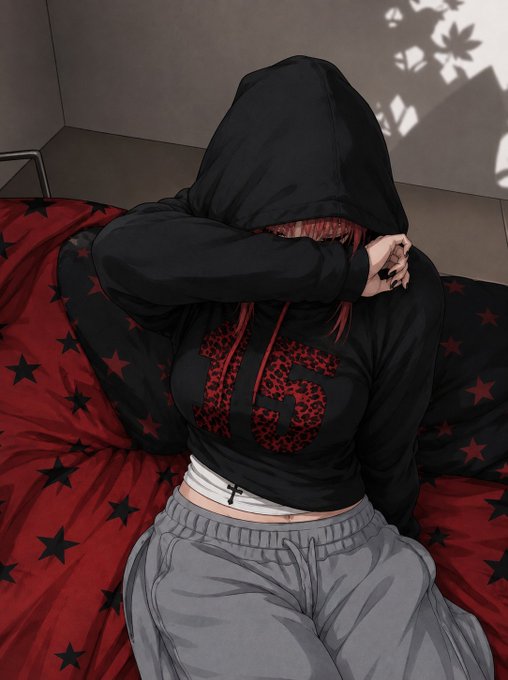 An illustration of a person wearing a black hoodie with a red logo and gray sweatpants, sitting on a red bed with black star patterns.