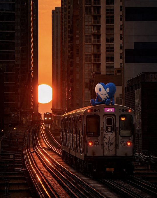 A blue cartoon mascot sits atop a Chicago "Loop" train (car #386) on elevated tracks, silhouetted against a vibrant orange sunset between city skyscrapers. The peaceful, "goodnight" vibe of the scene echoes the post's warm sign-off to the $CHANCE community, while the iconic Chicago transit ties into the project's city roots.