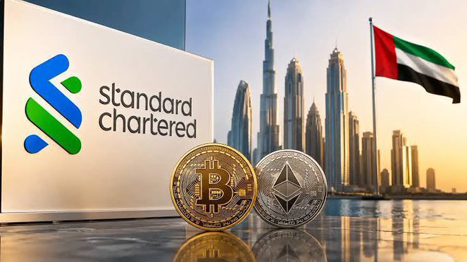 A composite image featuring the Standard Chartered logo and sign on the left, cryptocurrency coins (Bitcoin and Ethereum) in the foreground, the Burj Khalifa and Dubai skyline, and the UAE flag waving in the background.