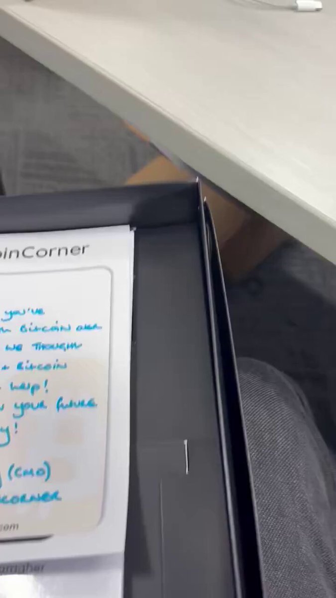 The image shows a black notebook with handwritten notes, including text about Bitcoin written by someone named Portnoy. The notebook appears to be open, and there are descriptions of Bitcoin written on it. The focus of this image is on the post that mentions the book "Bitcoin Explained Like I'm 5" and suggests resending the book to Portnoy.