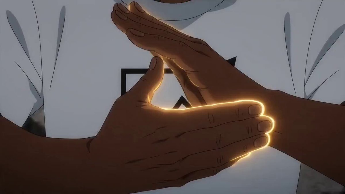 The image features an anime character with dark skin, wearing a white t-shirt that has a black logo on it. The character's hands are raised together in front of them, with their fingers spread out as if they're clapping or making a gesture. The background is a light gray color, which contrasts nicely with the dark skin tone and makes the character stand out even more. The post reads "I am a proud soylana manlet", indicating that this image was taken to celebrate the character's role in an anime series featuring a soylana.