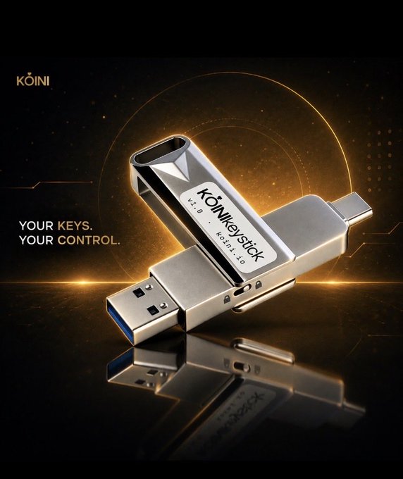 A product advertisement for a KŌINI branded KŌINkeystick hardware wallet featuring USB-A and USB-C connectors, with the tagline 'YOUR KEYS. YOUR CONTROL.' displayed against a dark golden background.