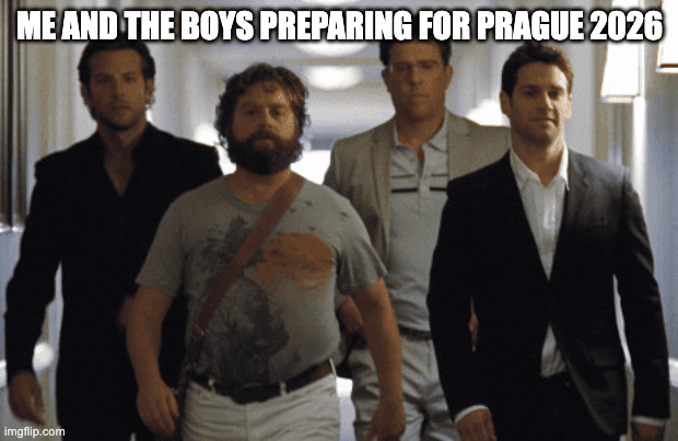 The image features a group of four men standing next to each other with their arms around one another's shoulders. They are all dressed in suits and ties, suggesting that they might be attending an important event or gathering. The caption for this image reads "Me and the boys preparing for Prague 2026".
