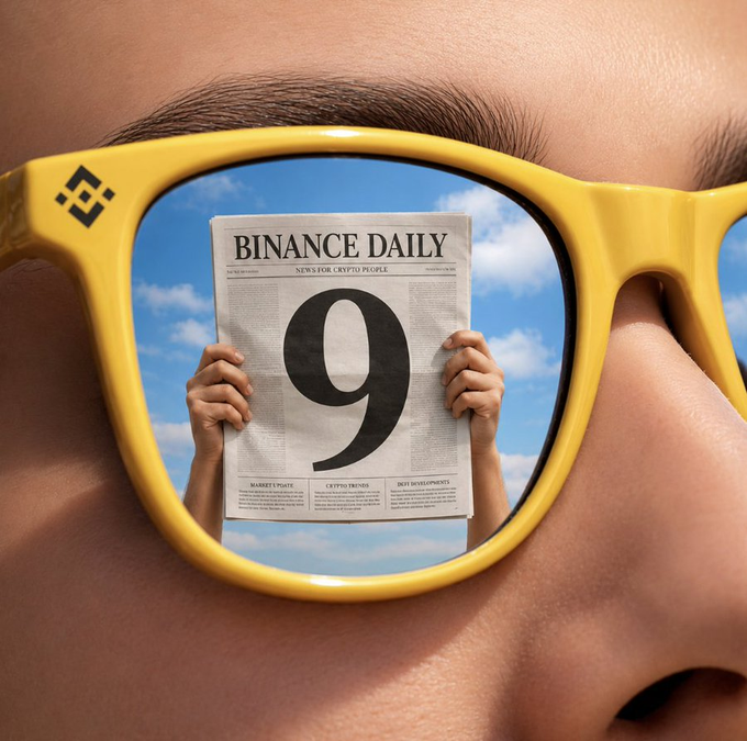 A close-up image of a person wearing yellow sunglasses (Binance logo on the side) that reflect a newspaper titled 'BINANCE DAILY' with a large '9' on the front page.