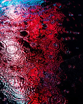 iced coffee with a red rim, featuring a gradient of colors from black to pink and blue.