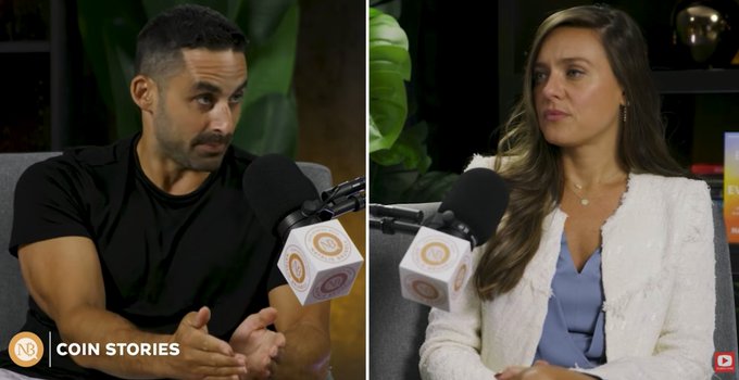 A split-screen interview shows a man speaking into a microphone and Nat Brunell listening on the Coin Stories channel. The overlay references the interviewer’s question about his loss of $1.6 million in Bitcoin in the ColdCard hack.
