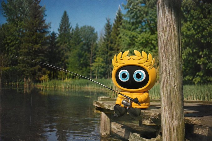 A cute yellow robot with a digital screen face and a laurel-like crown sits on a wooden dock, holding a fishing rod over a calm lake surrounded by pine trees.