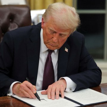 Donald Trump is shown signing a document, a fitting image for the accompanying post's call to pass the "CLARITY ACT" which he will personally approve.