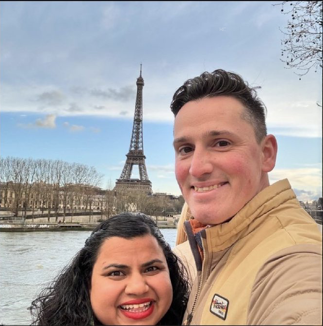 A couple takes a selfie in front of the Eiffel Tower along the Seine River, smiling brightly on what appears to be a chilly day. The image perfectly illustrates the post's caption of cashing out ZEC cryptocurrency profits at $1400 to fund a romantic Paris getaway with his wife.