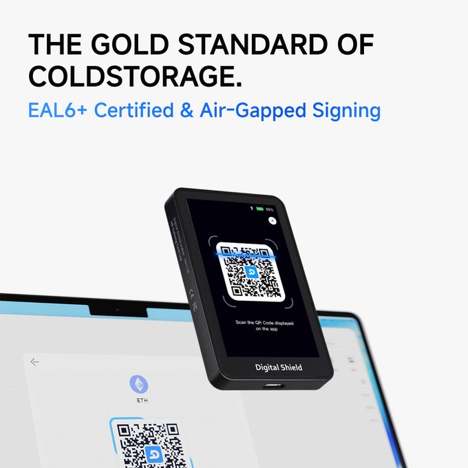 An advertisement reading 'THE GOLD STANDARD OF COLDSTORAGE. EAL6+ Certified & Air-Gapped Signing' showing a 'Digital Shield' hardware wallet scanning a QR code displayed on a laptop.